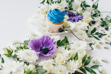 spring cupcake on a white background with flowers and fruits aro