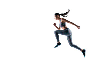 Side profile view full size full length portrait of sporty energetic serious healthy dynamic sportswoman frozen in motion, she is in running pose, isolated on white background, copyspace