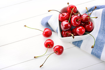 Fototapeta na wymiar Cherries on white wood background