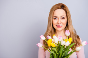 Fototapeta premium Lifestyle leisure international women's day concept. Close up portrait of lovely cute adorable excited delightful attractive woman holding white ans yellow tulips isolated on gray background
