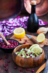 Delicious healthy cous cous salad with herbs, lemon zest, feta cheese and pomegranate seeds