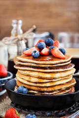 Stack of freshly prepared banana  pancakes with fresh berries
