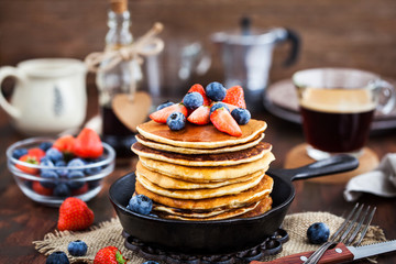 Stack of freshly prepared banana  pancakes with fresh berries