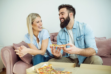 Couple eating pizza