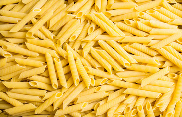 Raw pasta on the rustic wooden background. Selective focus. 