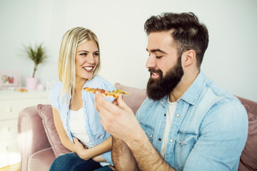Couple eating pizza