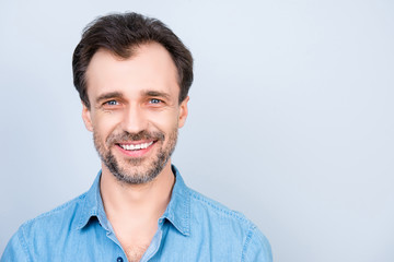 Fototapeta premium Close up front view portrait of mature cheerful excited satisfied glad virile masculine man wearing jeans denim shirt isolated on gray background empty blank place copyspace