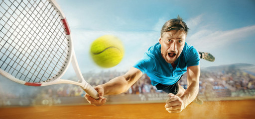 The one jumping player, caucasian fit man, playing tennis on the earthen court with spectators