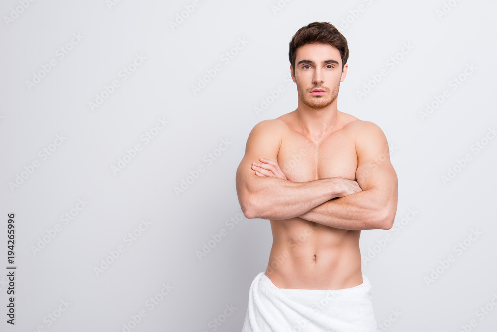 Wall mural Portrait of confident handsome attractive sexual with naked nude shirtless torso clean clear flawless ideal skin with white towel on hips isolated on gray background