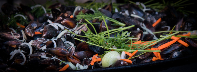 stewed mussels with onion, carrot and parsley