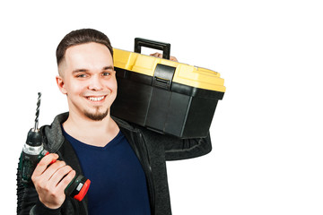 Young bearded man holding toolbox and screwdriver, confidently looking faoward. Isolated on white.