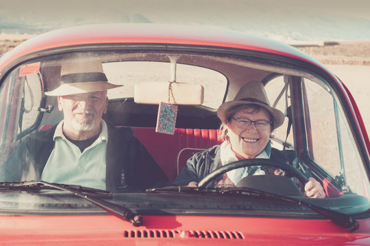 Elderly Senior Couple Inside A Old Red Car Driving And Having Fun