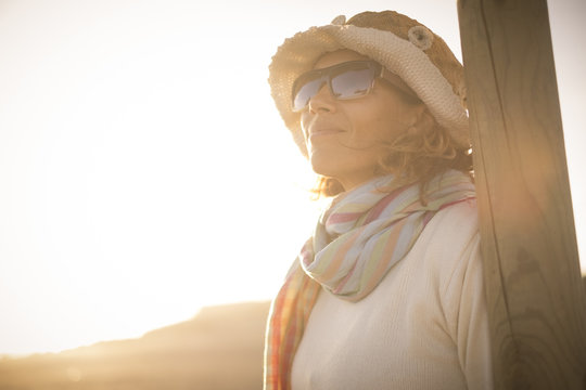 beautiful middle age woman llok at the sun in summer