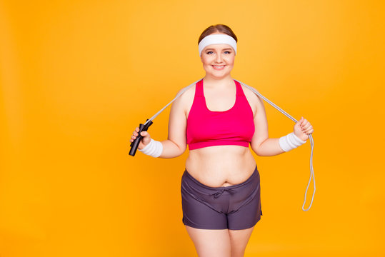 Young woman in exercise clothes holds jump rope