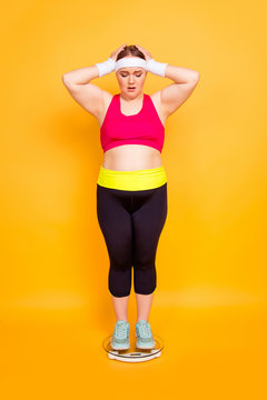 Young woman in exercise clothes with hands behind head