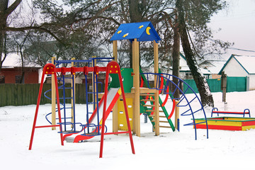 Children's swing. Winter. Playground