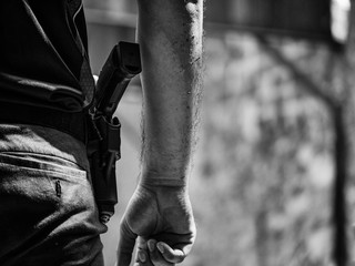 black and white image of male with handgun in holster standby for shooting competion