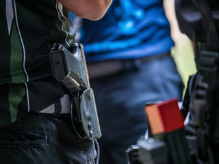 males with handgun in holster standby for shooting competion