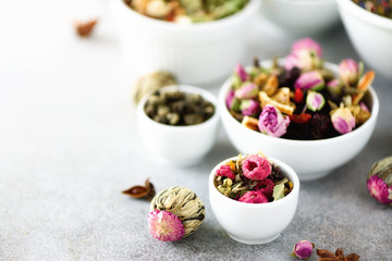 Assortment of dry tea in white bowls. Tea types backgound: green, black, floral, herbal, mint,...