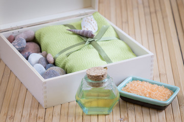 Healthy outfit for relaxation and SPA procedures with towel, stones and body oil