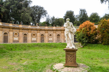 Antique ruined statue in park in Rome, Italy