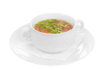 Soup of the ear, transparent with chicken, fish in white plate isolated white. On a napkin, with greens, carrots. Serving dishes in a cafe, restaurant, for a menu. Side view