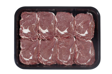 Plastic tray with lamb meat isolated on white background. Top view
