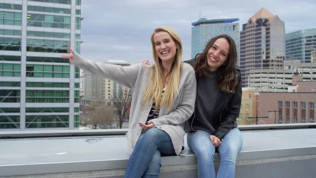 Friends Pose (Hold Up Peace Signs And Blow A Kiss) For Portrait On Rooftop In City - Shot On Red Scarlet-W Dragon In 4K/ Slow Motion