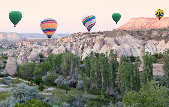 Colorful hot air balloons flying over Red valley in Cappadocia, Anatolia, Turkey