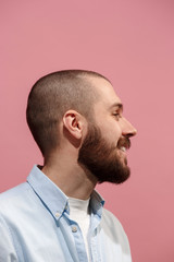 Fototapeta premium Isolated on pink young casual man smiling at studio