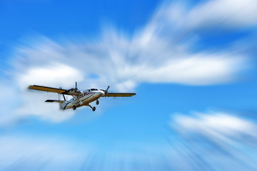 Small passenger propeller plane in the blue sky