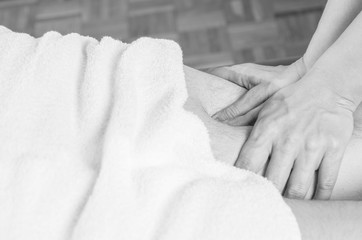 Obraz na płótnie Canvas physiotherapist doing a hamstrings massage to man patient. Osteopathy