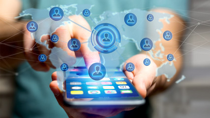 Businessman using a smartphone with a Network over a connected world map - 3d render