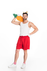Fototapeta na wymiar View of man with bunny ears holding big carrot on shoulder isolated on white, easter concept