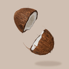 Cracked coconut on bright background. Summer tropical concept.