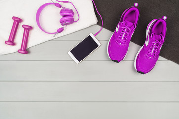 Fototapeta na wymiar Sport and fitness accessories, healthy and active lifestyle concept on wooden floor background with copy space. Products with vibrant, punchy pastel colours. Image taken from above, top view.