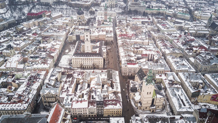 Fototapeta premium February, 2018 - Lviv, Ukraine. Top View of Lviv City Centre in snow from above in winter. Top view of city council.