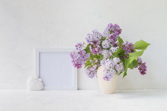 Mockup with a white frame and lilac branches