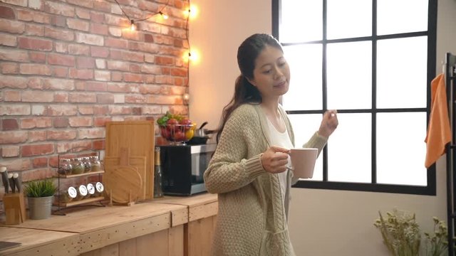 Woman dancing in the kitchen.