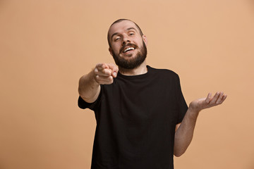 The happy business man point you and want you, half length closeup portrait on pastel background.