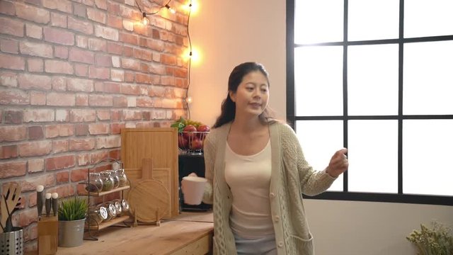 Woman playing music with a laptop.