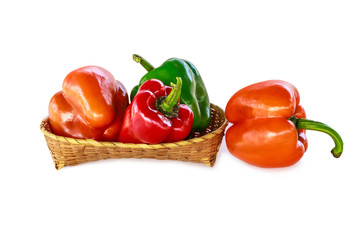 The bell pepper in the bamboo basket isolated on white background with clipping path.