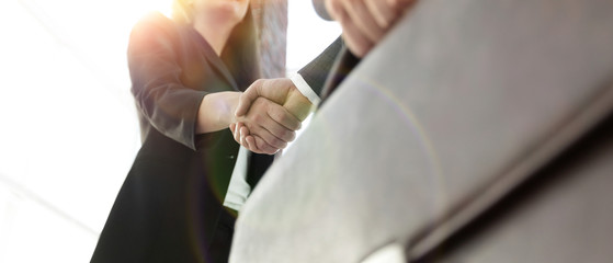 Close up of businessman and businesswoman shaking hands