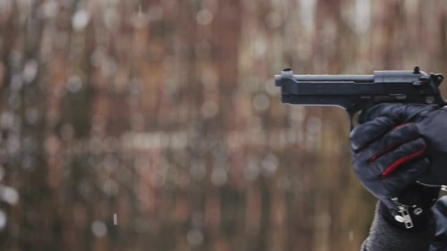 Snow falling outdoors agains bronw background slow motion