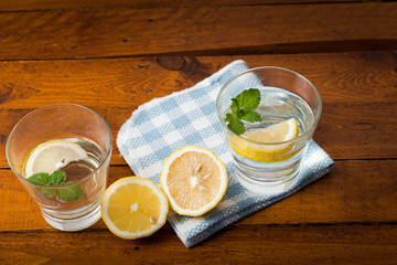 Lemonade with fresh lemon on wooden background


