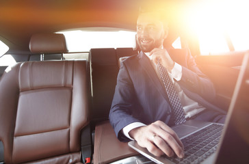 Confident businessman sitting in car