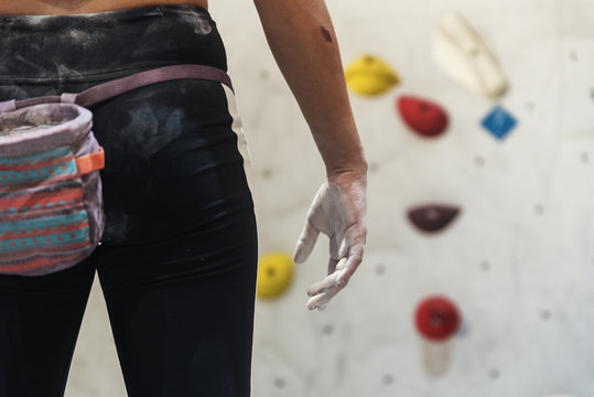 Close up of woman ready for practice rock climbing on artificial wall indoors.