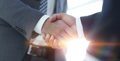 Businessman giving his hand for handshake to partner