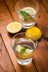 Lemonade with fresh lemon on wooden background

