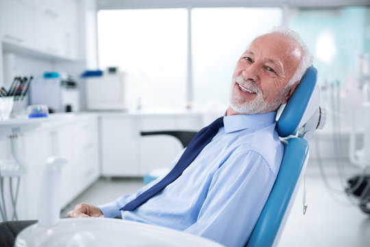 Elderly man in dentist's chair without fear waiting for treatment